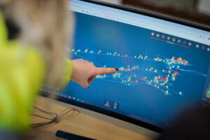 Person pointing to a computer screen