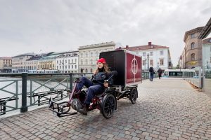 Woman driving cargo bike in Gothenburg