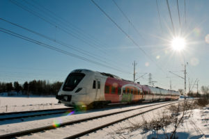 Train moving under a blue sky