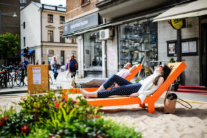 People in loung-chair in city