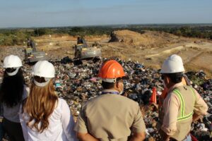 People looking at landfill in San Salvador