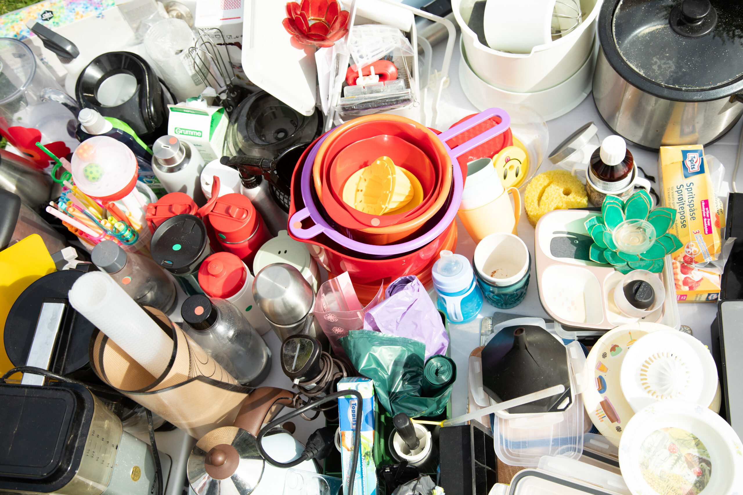 Cluttered assortment of kitchen and household plastic items.